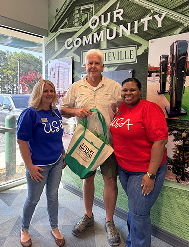 Member posing with two FBFCU Employees