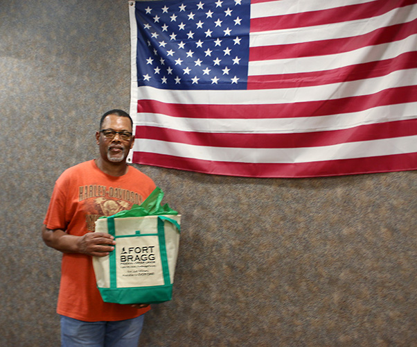 Member posing with flag