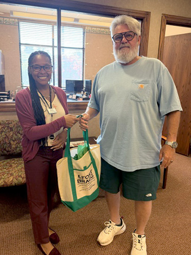 member receiving gift from employee