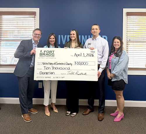 United Way and FBFCU Team members hold up donation check