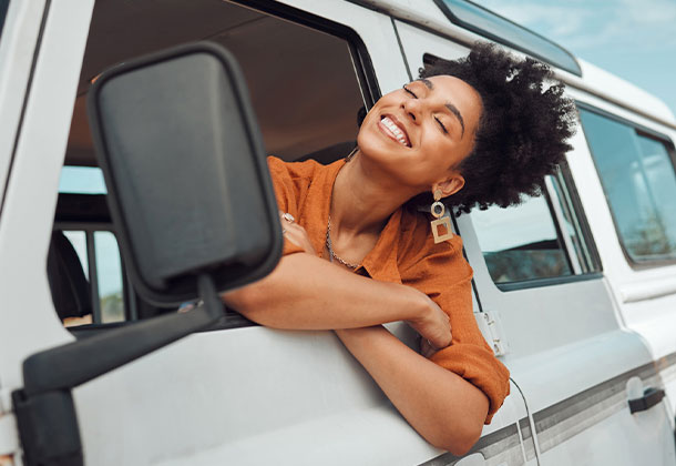 person leaning out of car window with breeze