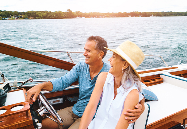 couple on a boat laughing in open water