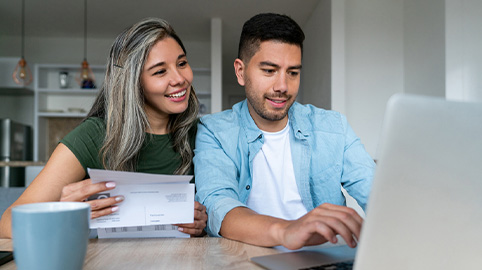 Happy couple going over finances