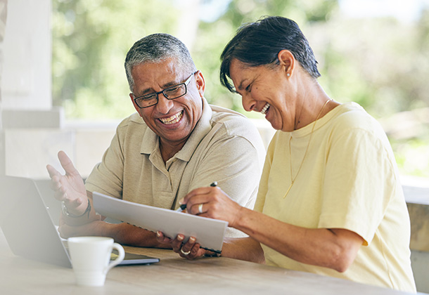 Happy older couple reviewing financials
