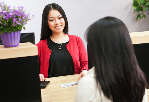 Two women working at a desk in office setting