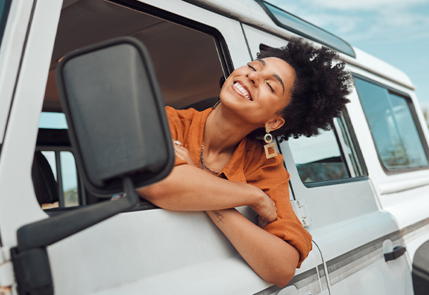 person leaning out of car window with breeze