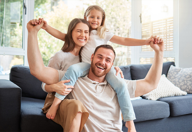 family of three people embracing at home