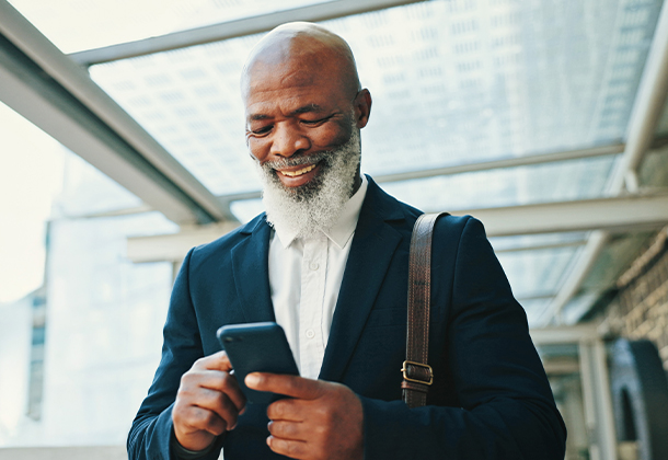 Man holding cell phone and smiling