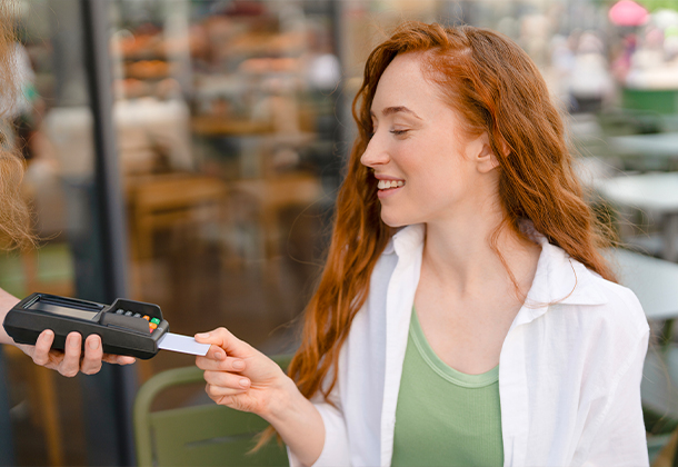person putting credit card into card reader