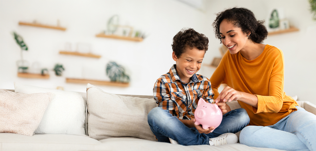 person and child holding piggy bank