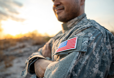 Servicemember standing proudly in uniform