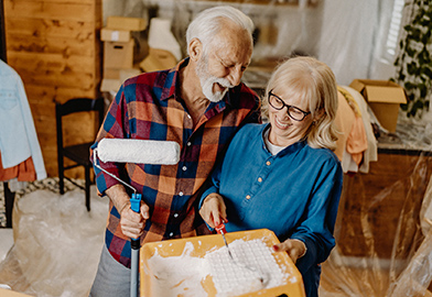 Older couple painting their house
